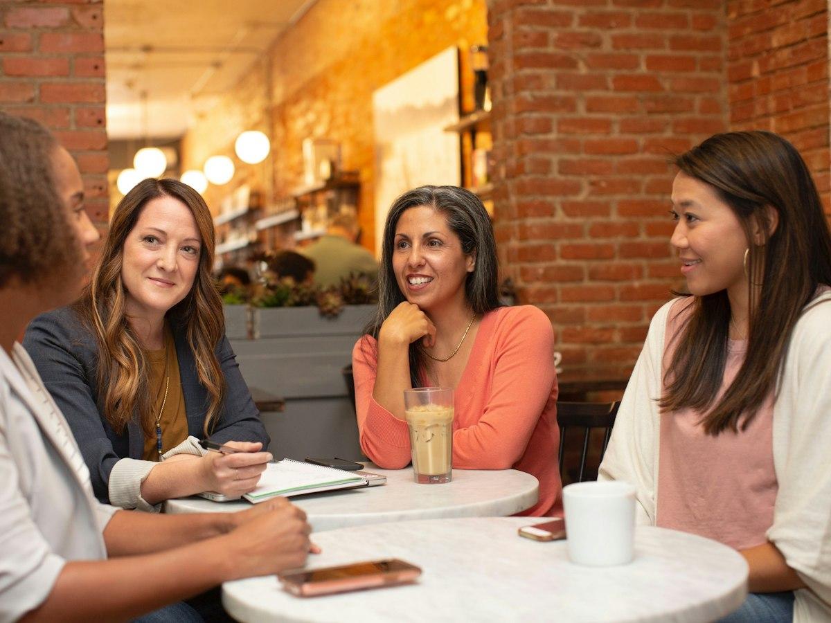 Colleagues laughing together over coffee