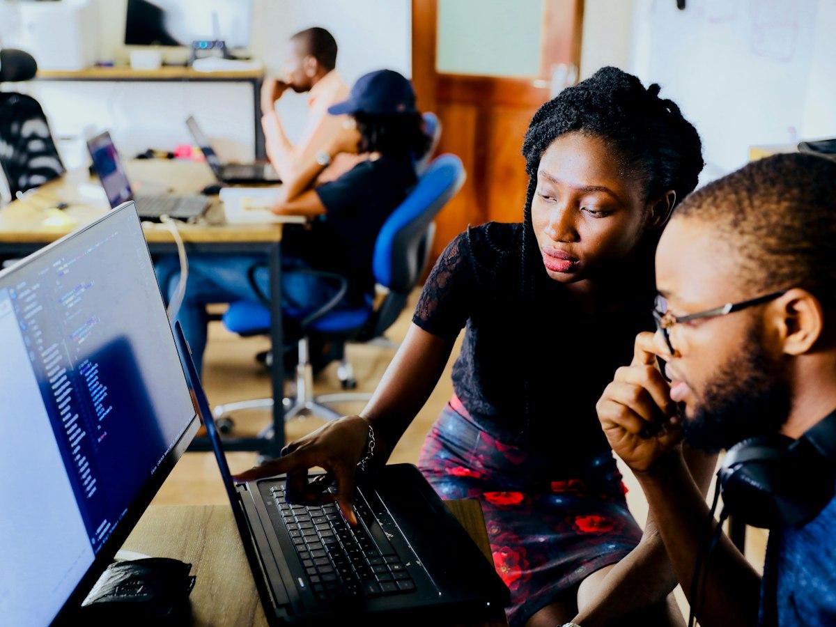 Two developers pairing at a laptop