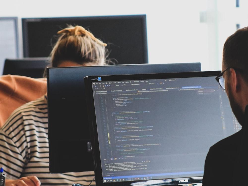 Engineers at their screens, working through code