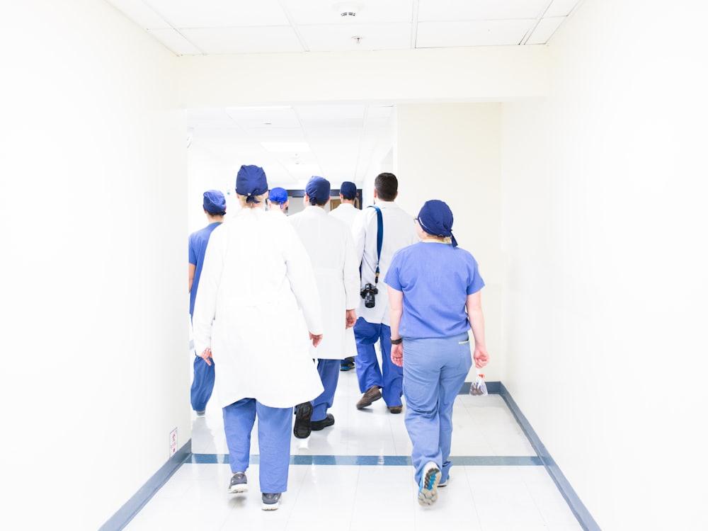 Hospital staff walking down a ward corridor