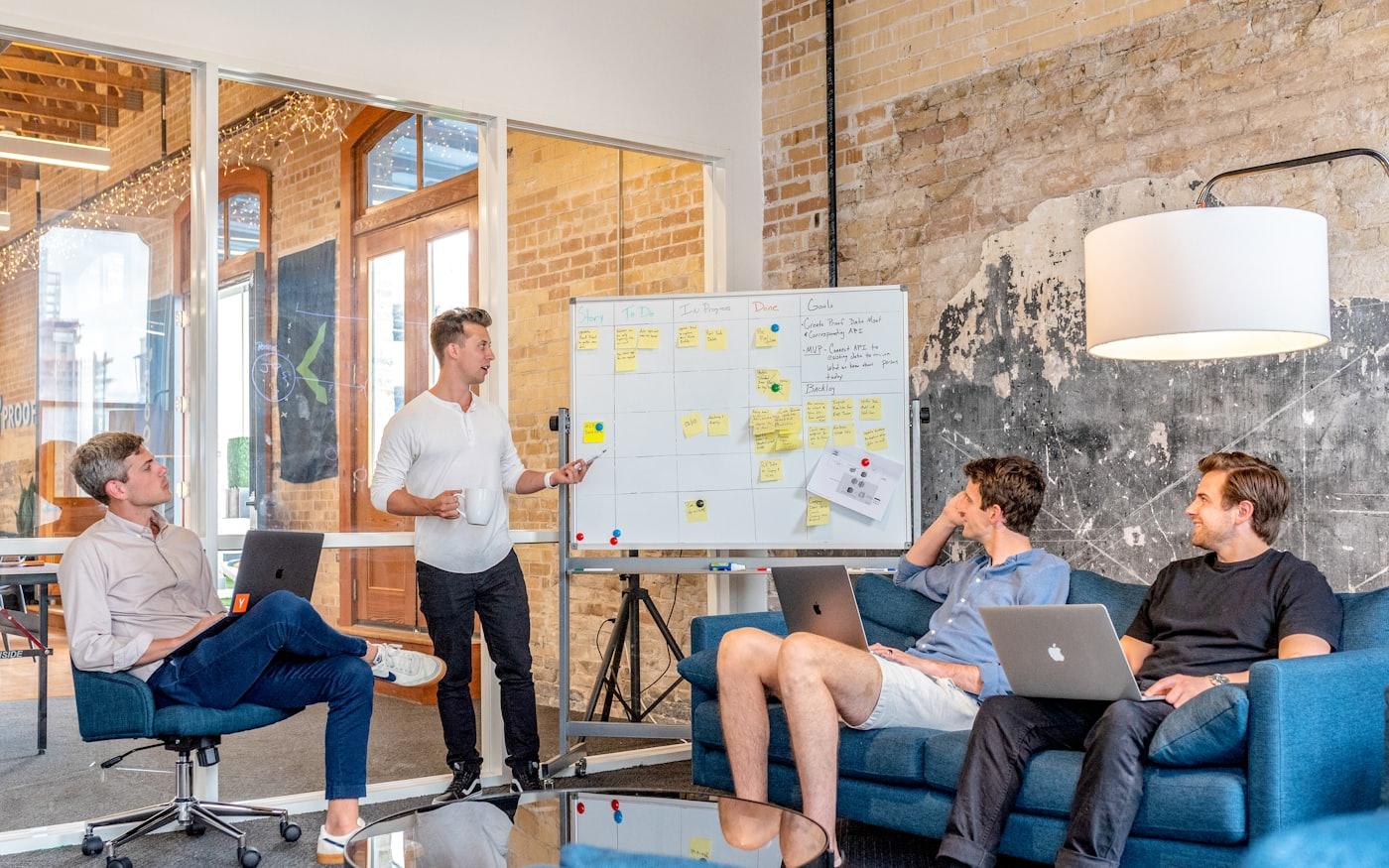 The team working through a problem on a whiteboard