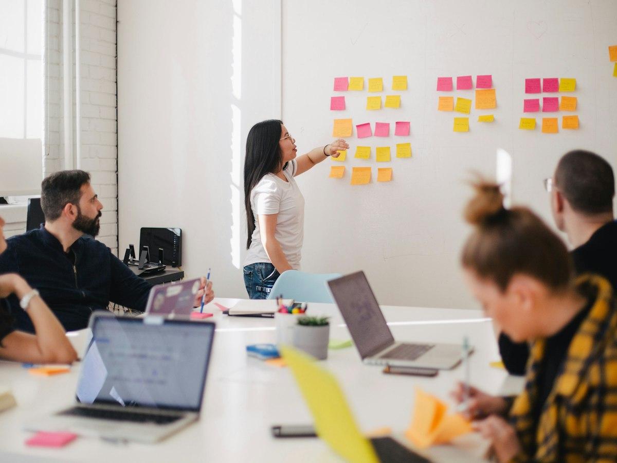 A team planning work with sticky notes on a wall
